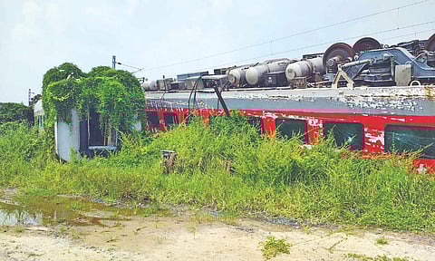 One of eight derailed coaches lying beside the railway tracks