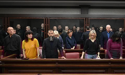 Lawyers of Ukrainian soldiers of the Aidar battalion captured by Russia during fighting in Ukraine stand in front of the defendants' cage during a hearing at the Southern District Military Court in Rostov-on-Don, Russia. (Photo: AP)