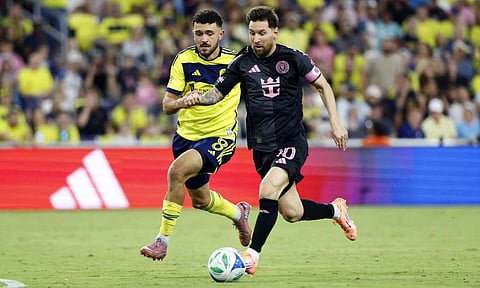 Lionel Messi dribbles past Patrick Yazbek of Nashville 