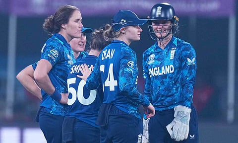 England's captain Nat Sciver-Brunt, left, celebrates with teammate the wicket of India's captain Harmanpreet Kaur during the ICC Women's Cricket World Cup match between India and England in Indore, India, Sunday, Oct. 19, 2025 (PTI) 