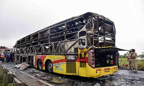 A Hyderabad-bound private bus after it caught fire following a collision with a two-wheeler, near Chinnatekur in Kurnool district, Andhra Pradesh, Friday, Oct. 24, 2025 (PTI) 