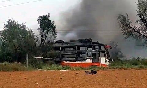 Charred remains of a private bus that caught fire after coming in contact with a hanging wire, at Manoharpur in Jaipur district, Rajasthan (PTI)