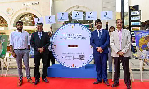 People install a clock as part of an awareness campaign on the World Stroke Day, in Mumbai (PTI)