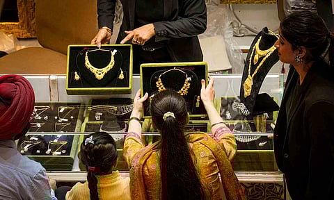 Customers at a jewellery shop on the occasion of the 'Dhanteras' festival, in New Delhi (PTI) 