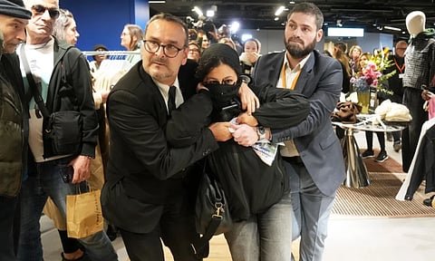 A protester is being evacuated from the BHV department store as fast fashion Shein opens its first physical store, Wednesday, Nov. 5, 2025 in Paris. (Photo: AP)