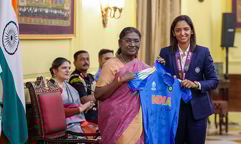 President Droupadi Murmu being presented the team's jersey by women's cricket team captain Harmanpreet Kaur during a meeting following the team's victory in the ODI World Cup at Rashtrapati Bhavan, in New Delhi, Thursday, Nov 6, 2025 (PTI)