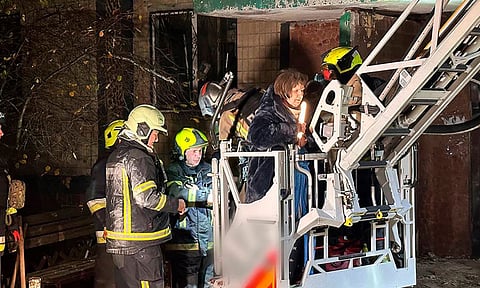 In this photo provided by the Ukrainian Emergency Service, firefighters evacuate a resident following a Russian rocket attack that hit a multi-storey apartment building in Dnipro, Ukraine (Photo: AP)