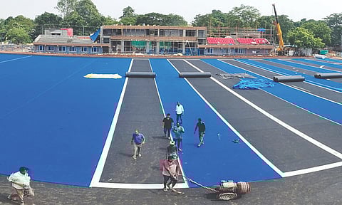 Astro turf pitch being laid at the MGR Stadium at Race Course, Madurai