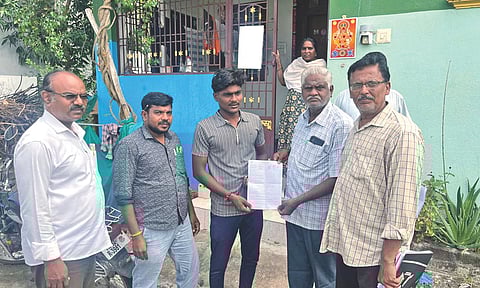 Booth level Officer (BLO) distributing the SIR forms. 