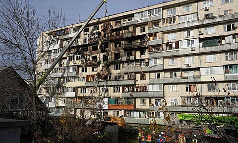 Rescuers work on the scene of a building damaged after a Russian attack in Kyiv, Ukraine, on Friday (AP)