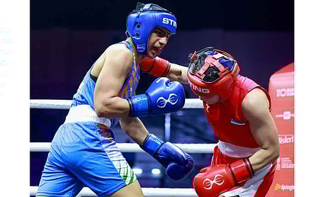 Preeti advances for a punch against Uktamova Nigina during the match 