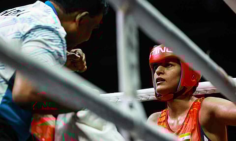 Jaismine Lamboria’s coach fires instructions as his boxer readies for next round 