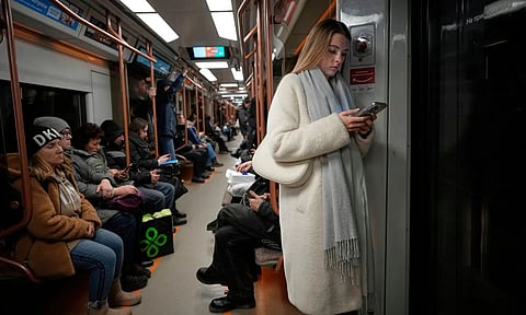 A woman looks at her smartphone on the subway in Moscow, Russia. (Photo: AP)