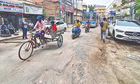 Potholes and bumps are visible on the entire stretch