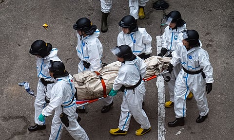 Police remove what appears to be a body bag from the site of a deadly Wednesday fire at Wang Fuk Court, a residential estate in the Tai Po district of Hong Kong’s New Territories on Sunday, Nov. 30, 2025. (AP)