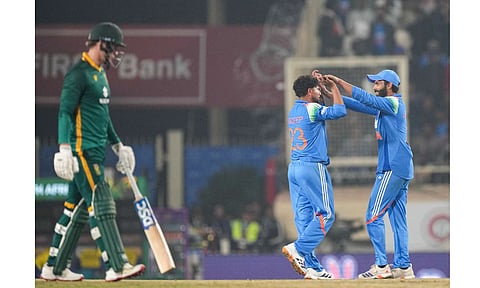 India's Kuldeep Yadav, back left, celebrates with Ravindra Jadeja, right, after taking the wicket of South Africa's Prenelan Subrayen during the first ODI cricket match of a series between India and South Africa, at JSCA International Stadium Complex, in Ranchi, Jharkhand, Sunday, Nov. 30, 2025 (PTI) 