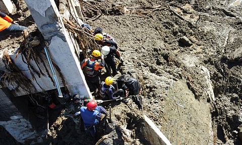 Rescuers recover the body of a flood victim in Padang Panjang, West Sumatra, Indonesia. (Photo: AP)