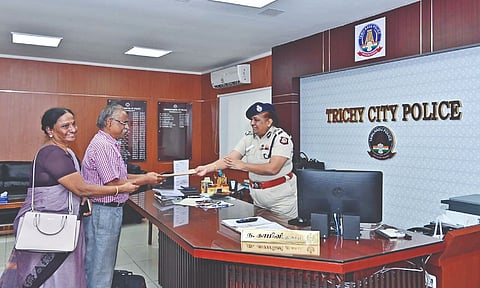 Tiruchy City Commissioner of Police N Kamini handing over the statement of account copy to victim Raja Perumal on Monday