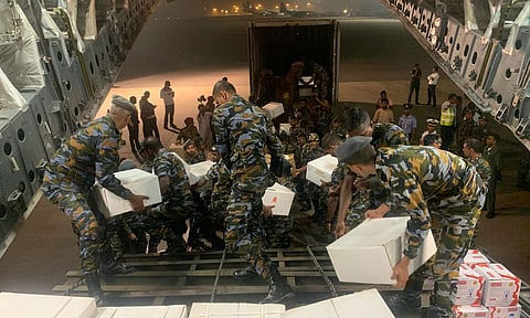 Security personnel carry relief materials (Photo: PTI)