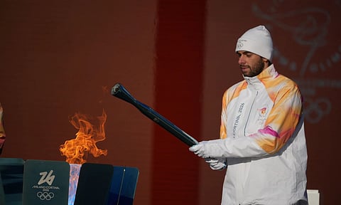 Italian swimmer Gregorio Paltrinieri lights the 2026 Milan Cortina Winter Olympics torch in Rome as it begins its journey through Italy, Saturday, Dec. 6, 2025, a journey that will conclude in Milan in February 2026. (AP)