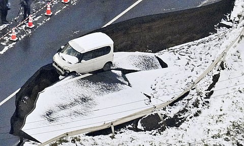 This aerial photo shows a vehicle sitting on a damaged road in Tohoku town, Aomori prefecture, northern Japan Tuesday, Dec 9, 2025, following a powerful earthquake on late Monday (AP)
