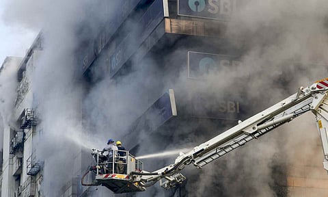 Firefighters try to douse a fire that broke out at Swagota Square, Sohum Emporia, in Guwahati, Wednesday, Dec. 10, 2025 (PTI) 