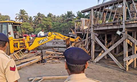 An excavator demolishes wooden structures at Romeo Lane on Anjuna beach after a fire at the adjacent Birch by Romeo Lane nightclub killed 25 people, as the state administration begins pulling down the tourism property, in Goa (PTI) 
