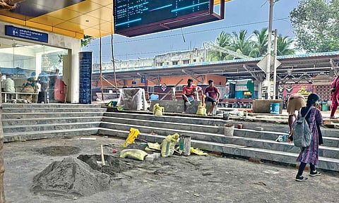 Passengers walking amidst redevelopement works inside Mambalam railway station.