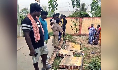 Students and villagers looking at the debris of the collapsed wall in the government school premises in Kondapuram