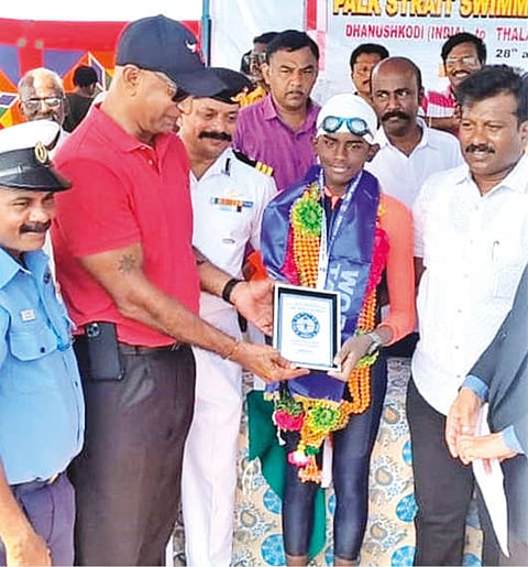 Officials felicitating NA Snehan for setting a new record of 19 hours 45 minutes in two-way swimming across Palk Strait