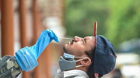 A health worker taking a swab sample from a person