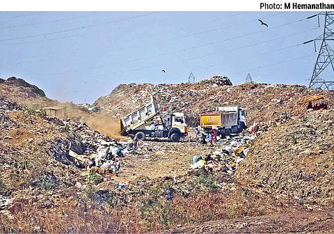 Trucks clearing garbage at Kodungaiyur dumpyard