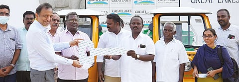 Dr Suresh Ramanathan, Dean, Great Lakes, presents electric vehicles to president of Manamai panchayat