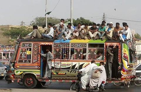 People travel on a bus in Pakistan's business city of Karachi