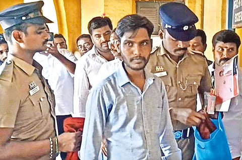 BJP youth wing functionary Vignesh being brought to a court in Karur on Tuesday