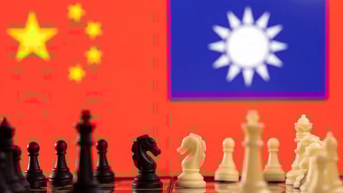 Chess pieces are seen in front of displayed China and Taiwan's flags in this illustration