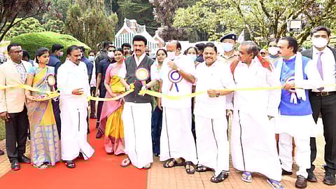 Stalin cutting the ribbon to inaugurate the flower show.