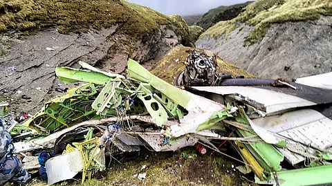 Wrecked Twin Otter aircraft laying on a mountainside