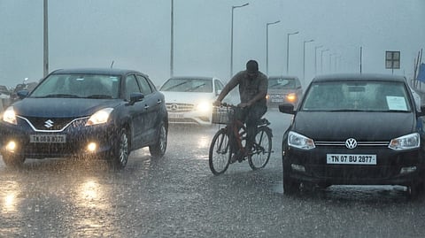 Vehicles headlight turned on amidst heavy rain on beach road