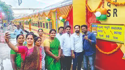 Passengers take selfie in front of Madurai-Theni train on Thursday