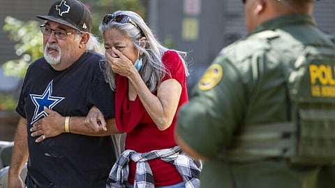 A woman cries as she leaves the Uvalde Civic Center in Uvalde, Texas, following a deadly school shooting in the town.