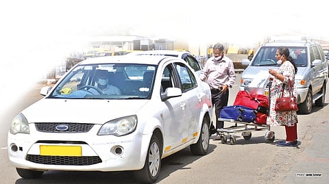 A couple loading their luggage in a cab before boarding