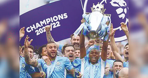 Manchester City players celebrate the win with Premier League trophy