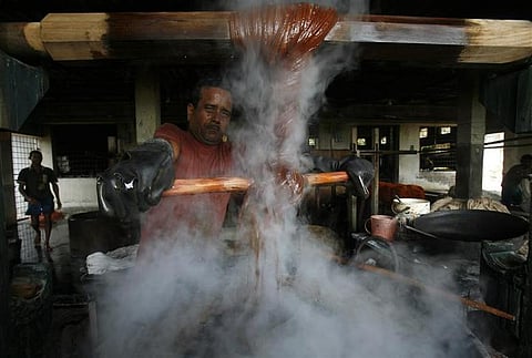 A labourer dyes yarn prior to weaving