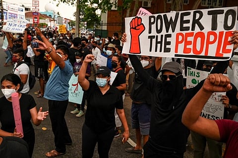 Protesters hold banners and placards during a demonstration