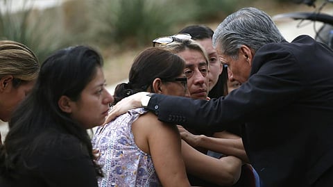 The Archbishop comforts families outside of the Civic Center