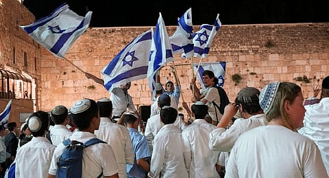 Members of Jewish youth movements dance and wave Israeli flags on the eve of Jerusalem Day