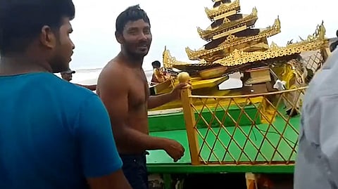 People dragging the chariot out to the shore