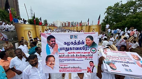 An EPS supporter holding a placard with slogan supporting the leader.