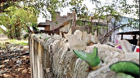 Broken glass pieces crown the eight-foot-tall wall at Thokkamour colony so that Dalits won?t scale it.